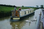 Oxford Canal (Southern Section): Priors Hardwick Bridge No 123, Boat and swan with cygnets - May 1999.